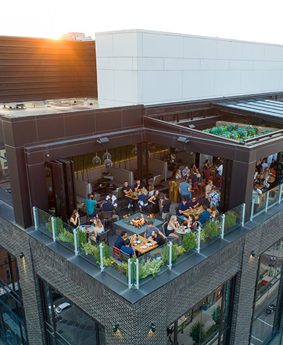 Drone view of Lincoln Social rooftop with guests enjoying outdoor patio in Columbus, Ohio